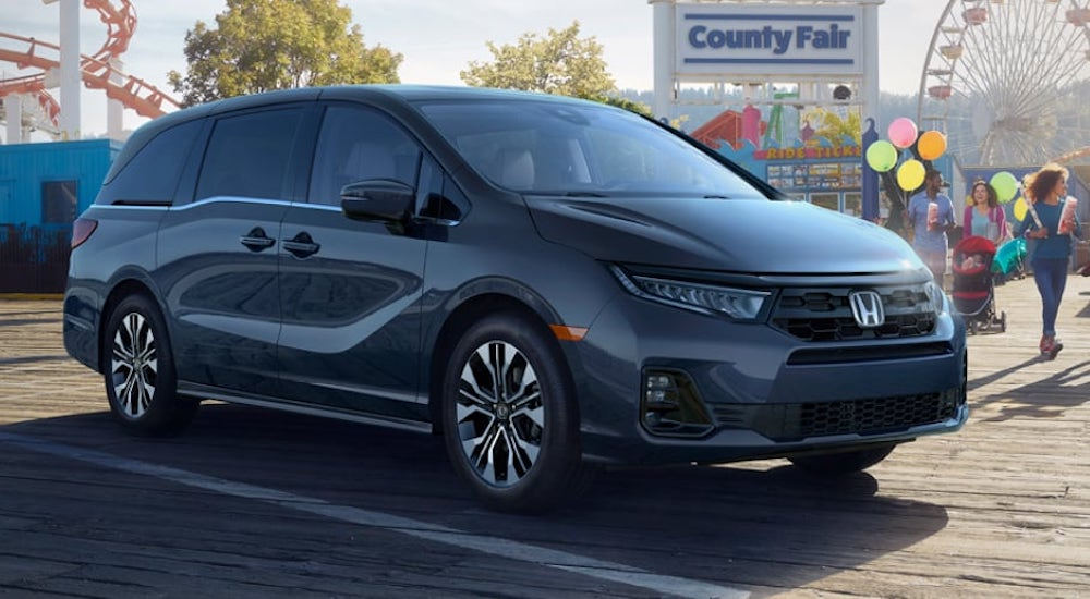 A black 2025 Honda Odyssey is shown from the front at an angle.