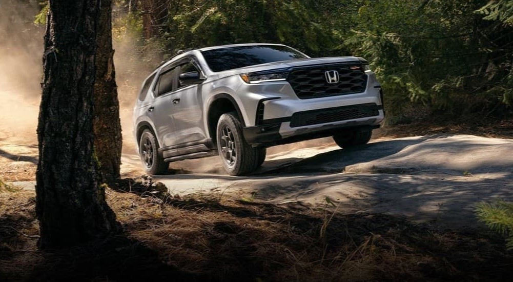 A gray 2025 Honda Pilot Trail Sport off-roading.