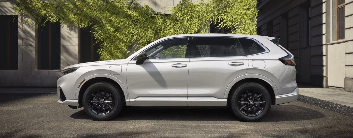 White 2025 Honda CR-V eFCEV parked near an wall covered in ivy