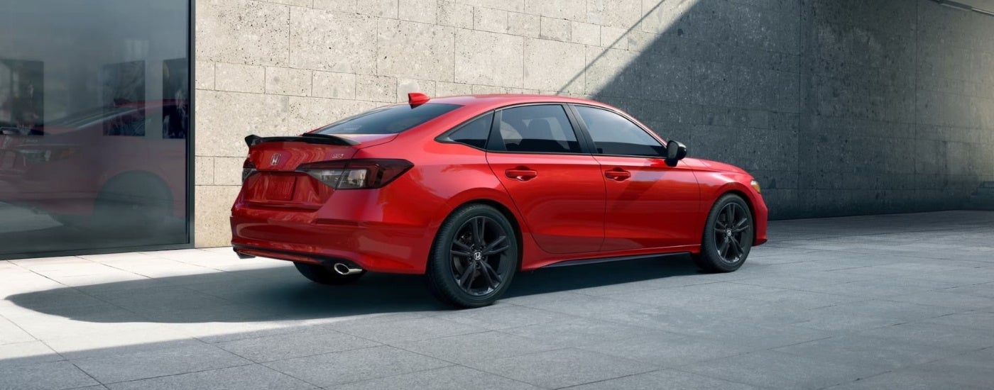 Red 2025 Honda Civic Si parked in front of a building