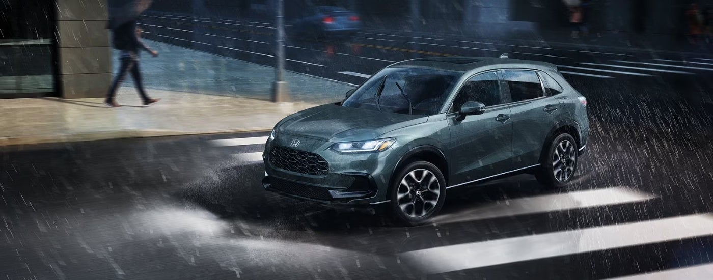 Blue 2027 Honda HR-V EX-L driving through the rain