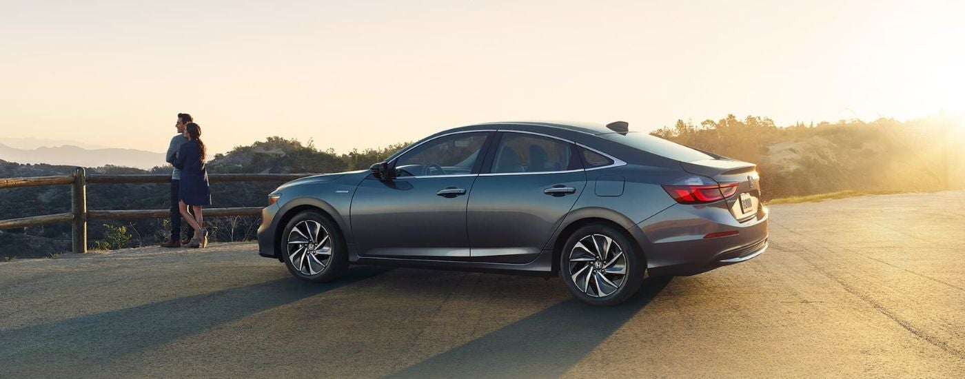 A grey 2021 Honda Insight is shown from the side parked on a conrete.
