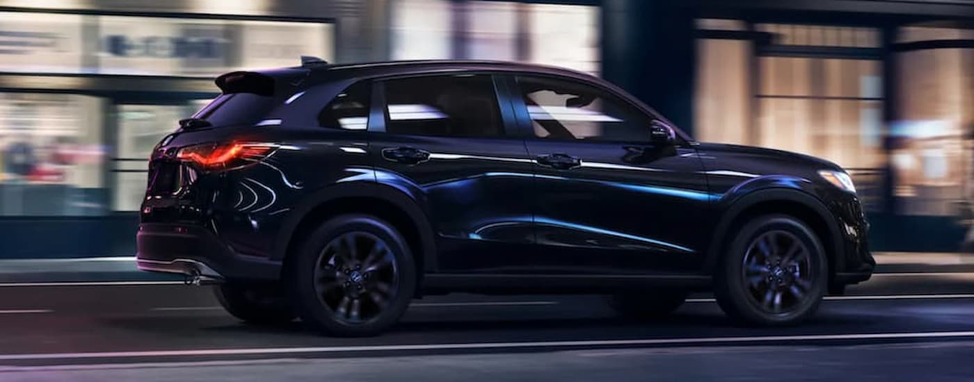 A black 2026 Honda HR-V driving in a city from a Honda Dealer near Beech Grove