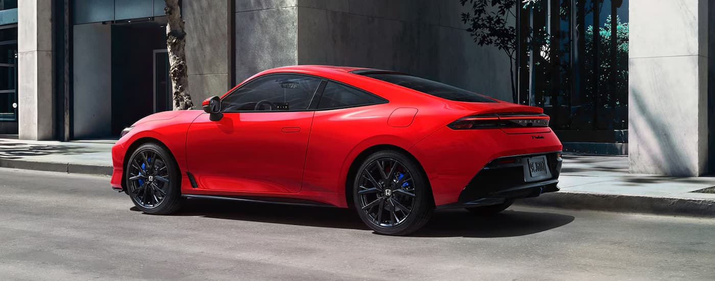 A red 2026 Honda Prelude parked in a city