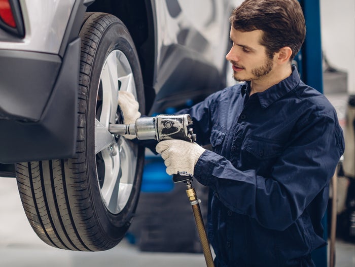 Service tech working on a vehicle